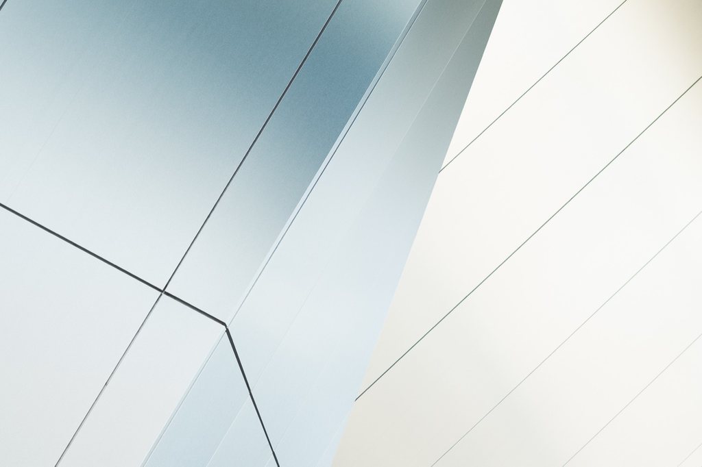 White architectural planes and seams against open sky.